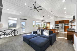 Living room with high vaulted ceiling, ceiling fan, wood ceiling, dark hardwood / wood-style floors, and sink