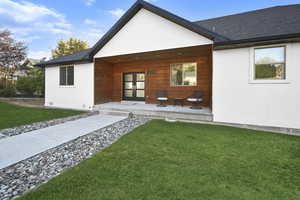 Rear view of property featuring a lawn