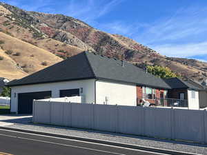 View of side of home featuring a mountain view and a garage