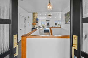 Kitchen with hardwood / wood-style flooring, ceiling fan, and hanging light fixtures