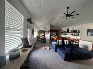 Living room with ceiling fan, dark wood-type flooring, vaulted ceiling, and wooden ceiling