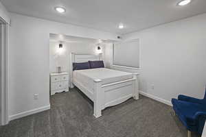 Bedroom with dark colored carpet