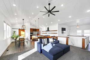 Living room with dark wood-type flooring, wood ceiling, vaulted ceiling, and ceiling fan