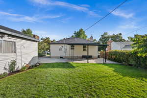 Back of house featuring a yard and a patio