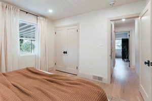 Bedroom featuring light wood-type flooring and a closet