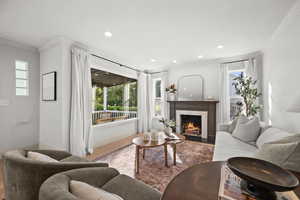 Living room featuring ornamental molding and hardwood / wood-style floors