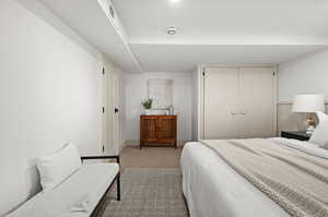 Carpeted bedroom with a closet