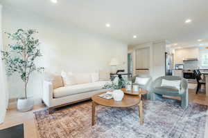 Living room featuring crown molding and light hardwood / wood-style floors