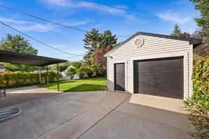 Garage with a yard and a carport