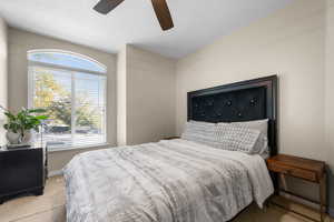 Carpeted bedroom featuring ceiling fan
