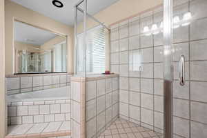Bathroom with tile patterned flooring and separate shower and tub