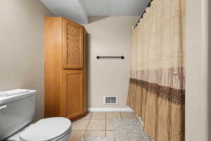 Bathroom with tile patterned floors and toilet