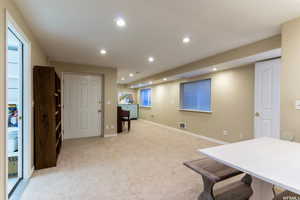 Interior space with recessed lighting, baseboards, light colored carpet, and visible vents