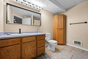 Bathroom with vanity, tile patterned flooring, and toilet