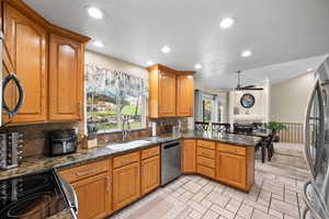 Kitchen featuring sink, stainless steel appliances, kitchen peninsula, and a wealth of natural light