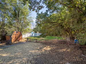 View of yard featuring a storage unit