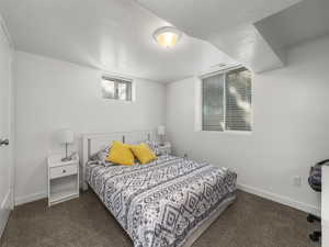 Carpeted bedroom with a textured ceiling