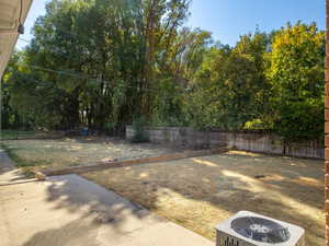 View of yard featuring central AC unit and a patio