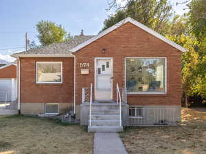 View of front facade featuring a garage and a front lawn