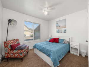 Bedroom with ceiling fan and carpet floors