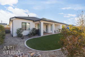 Single story home featuring a front yard, central AC unit, and a patio