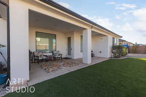 Back of house featuring a patio area and a lawn