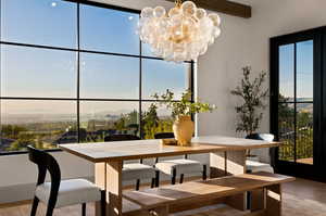 Dining space featuring an inviting chandelier and light wood-type flooring