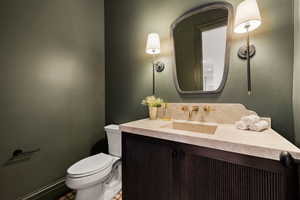 Bathroom with vanity, toilet, and tile patterned floors