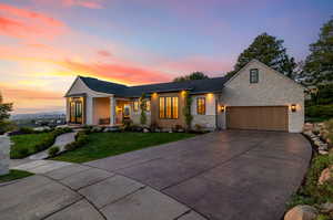 View of front facade with a yard and a garage