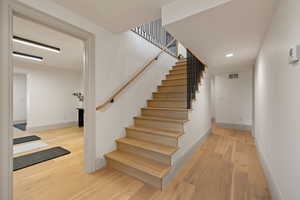 Stairway featuring hardwood / wood-style floors