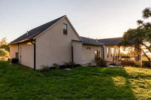 Rear view of house featuring cooling unit, a patio, and a lawn