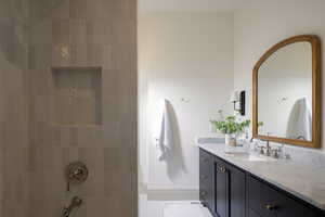 Bathroom with vanity and tiled shower / bath