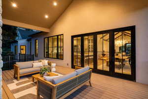 Deck with an outdoor hangout area and french doors