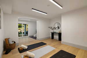 Workout area featuring light hardwood / wood-style floors