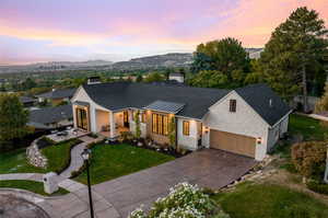 Modern farmhouse featuring a garage, a yard, and a mountain view