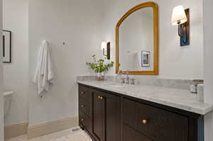 Bathroom with toilet, tile patterned flooring, and vanity