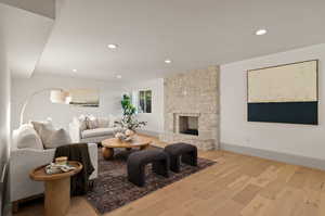 Living room with light wood-type flooring and a fireplace