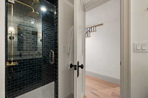 Bathroom featuring walk in shower and hardwood / wood-style floors