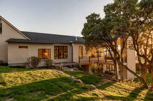 Rear view of house featuring a yard