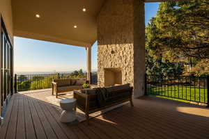 Deck at dusk with an outdoor hangout area and a yard