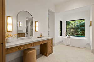 Bathroom featuring vanity, a bathtub, and parquet floors