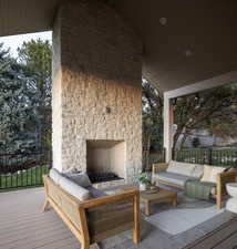 Deck featuring an outdoor living space with a fireplace