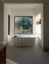 Bathroom with a washtub and vanity