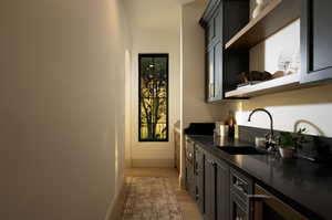 Bar featuring sink and light wood-type flooring