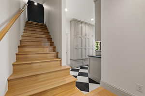 Staircase featuring wood-type flooring