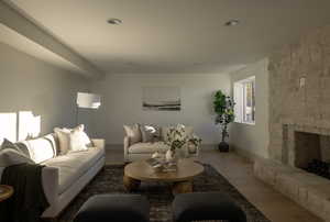 Living room with wood-type flooring and a stone fireplace