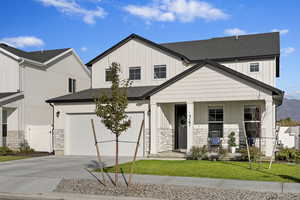 Street View with 2 car garage, open porch, and landscaped lawn.