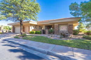 View of front of house featuring a garage and a front lawn