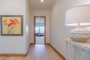 Hallway with light wood-type flooring