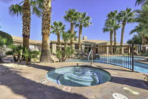 View of pool featuring a patio area and a hot tub